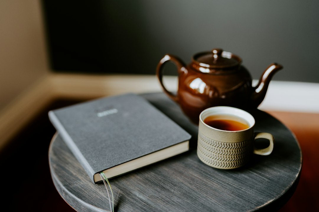 Notebook and cup of tea on a wooden table