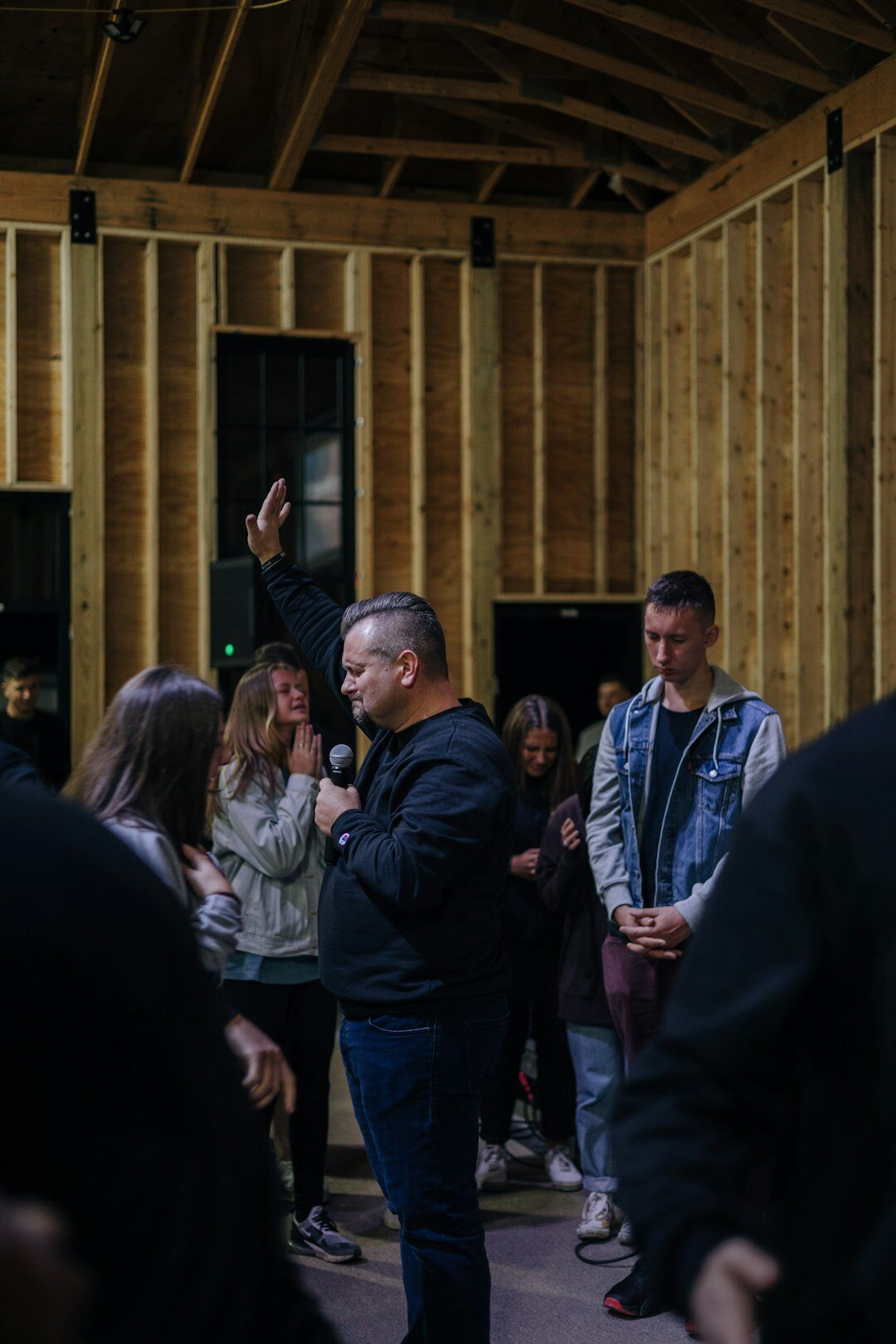 Man speaking to a small group indoors
