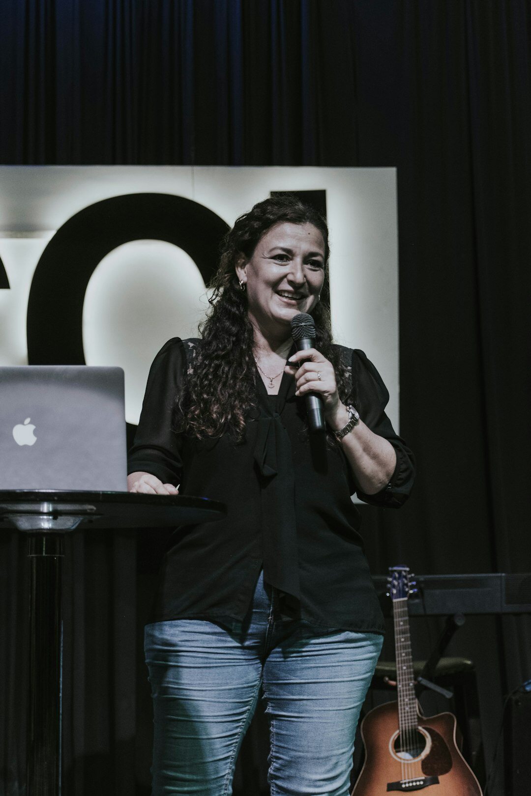 woman speaking confidently on stage